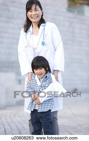 Stock Image - Boy with Broken Arm and Female Doctor. Fotosearch