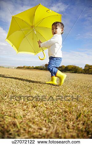 Boy with Yellow Umbrella in Field View Large Photo Image Stock Image - Boy with Yellow Umbrella in Field. Fotosearch