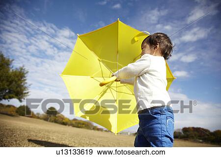 Boy with Yellow Umbrella in Field View Large Photo Image Stock Photo - Boy with Yellow Umbrella in Field. Fotosearch