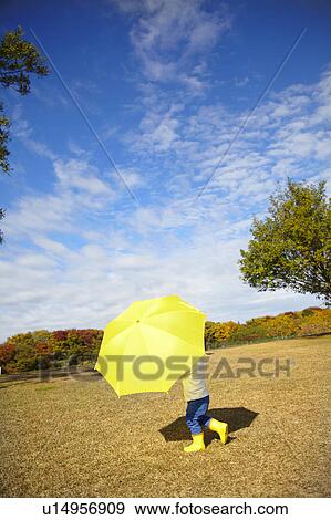 Boy with Yellow Umbrella in Field View Large Photo Image Stock Photo - Boy with Yellow Umbrella in Field. Fotosearch