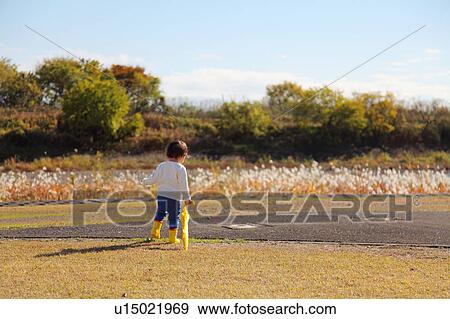 Boy with Yellow Umbrella in Field View Large Photo Image Stock Photo - Boy with Yellow Umbrella in Field. Fotosearch