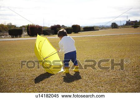 Boy with Yellow Umbrella in Field View Large Photo Image Stock Photography - Boy with Yellow Umbrella in Field. Fotosearch