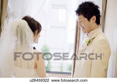 Bride and bridegroom standing face to face View Large Photo Image Stock Image - Bride and bridegroom standing face to face. Fotosearch