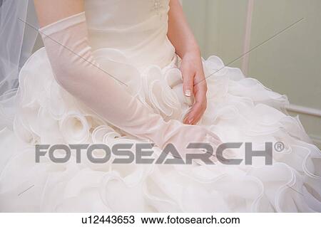 Stock Image - Bride wearing a glove . Fotosearch