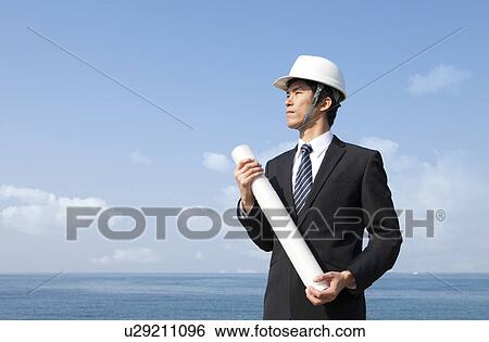 Stock Photograph - Businessman Wearing Hardhat. Fotosearch