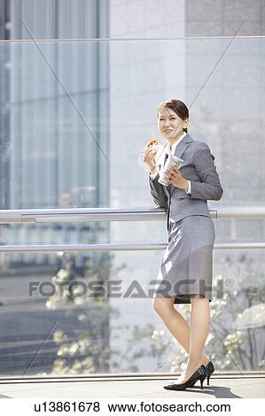 Stock Photo - Businesswoman Having Lunch. Fotosearch