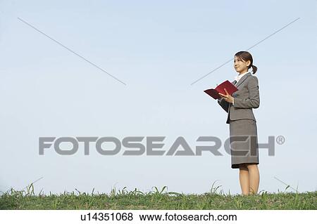 Businesswoman Making Notes in Field View Large Photo Image Stock Photo - Businesswoman Making Notes in Field. Fotosearch