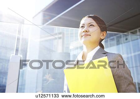 Stock Image - Businesswoman with File. Fotosearch