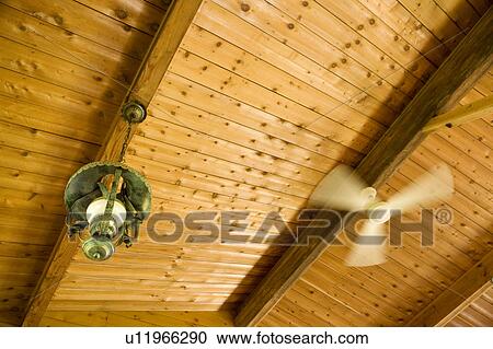 Ceiling Fan And A Lamp In A Log Cabin Stock Image