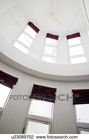 Stock Image - Ceiling fan and windows. Fotosearch