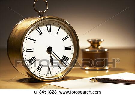 Stock Photo - Clock, fountain pen and paper. Fotosearch