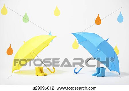 Stock Image - Colourful Raindrops Falling on Umbrellas and Rubber Boots. Fotosearch