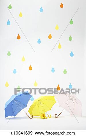 Stock Photo - Colourful Raindrops Falling on Umbrellas and Rubber Boots. Fotosearch