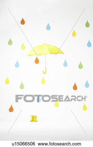 Stock Photograph - Colourful Raindrops Falling on Yellow Umbrella and Rubber Boots. Fotosearch