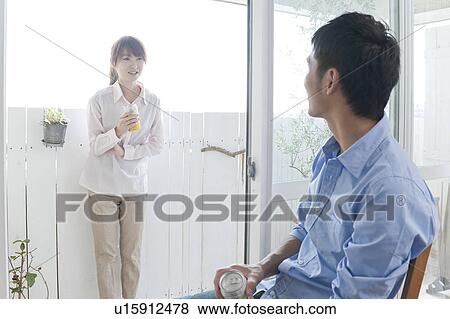 Couple talking with beers in hands View Large Photo Image Stock Photo - Couple talking with beers in hands. Fotosearch