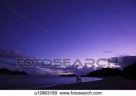Couple Walking at Beach at Dusk View Large Photo Image Stock Photo - Couple Walking at Beach at Dusk. Fotosearch
