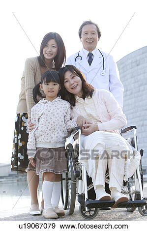 Stock Photo - Daughter and Granddaugther Visitng Woman in Hospital. Fotosearch