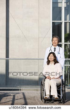 Doctor and Mature Woman in Wheelchair View Large Photo Image Picture - Doctor and Mature Woman in Wheelchair. Fotosearch