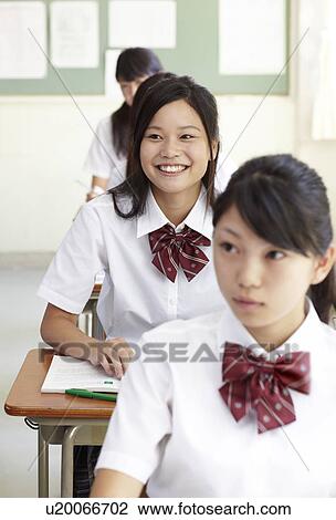 Stock Image - Female High School Students in Classroom. Fotosearch