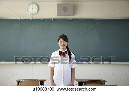 Stock Photo - Female Student by Blackboard. Fotosearch