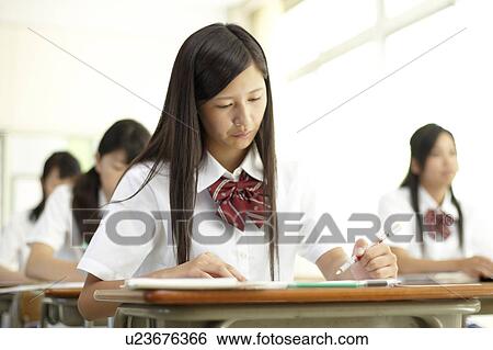Stock Photograph - Female Student Studying in Classroom. Fotosearch