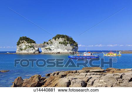 Stock Image - Fishing Boats and Engetsuto Rock Formation. Fotosearch