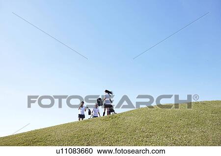 Stock Image - Four Schoolgirl on Hill. Fotosearch