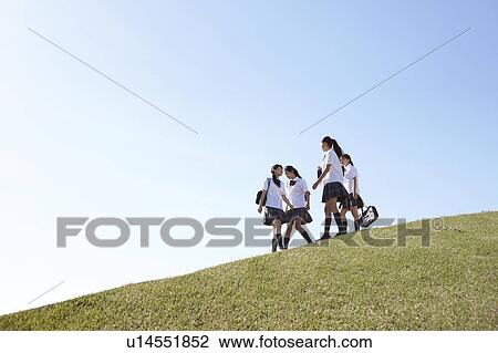 Stock Image - Four Schoolgirl on Hill. Fotosearch