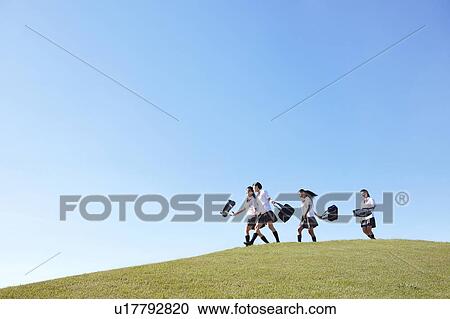 Stock Image - Four Schoolgirl on Hill. Fotosearch