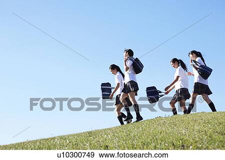 Stock Photo - Four Schoolgirl on Hill. Fotosearch