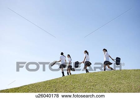 Stock Photo - Four Schoolgirl on Hill. Fotosearch