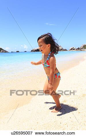 Stock Photo - Girl (3 yr) on Beach. Fotosearch