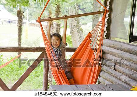 Girl hanging from hammock View Large Photo Image Stock Image - Girl hanging from hammock. Fotosearch