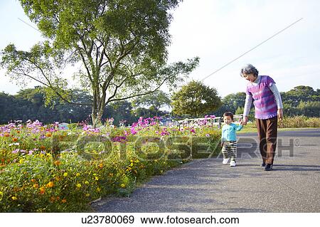 Grandmother and Granddaughter Walking Hand in Hand View Large Photo Image Stock Photo - Grandmother and Granddaughter Walking Hand in Hand. Fotosearch