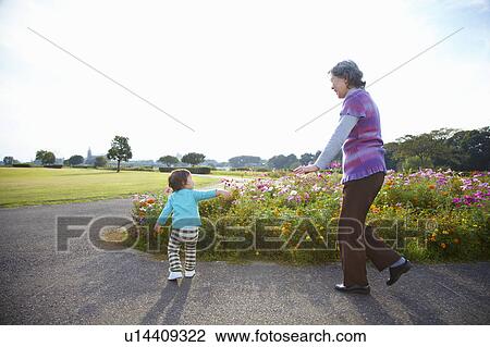 Grandmother and Grandson Walking in Park View Large Photo Image Stock Image - Grandmother and Grandson Walking in Park. Fotosearch
