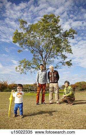 Stock Photography - Grandparents and Father Watching Boy. Fotosearch