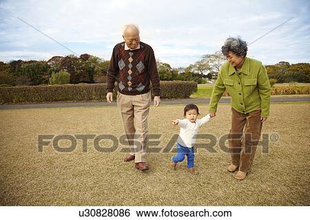 Stock Photograph - Grandparents and Grandson Walking. Fotosearch