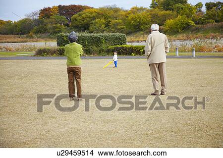 Picture - Grandson Playing Baseball with Grandparents. Fotosearch