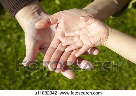Stock Image - Hands of Grandparents and Grandson. Fotosearch