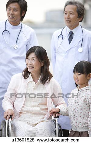 Stock Photo - Hospital Staff with Mature Woman and Granddaughter. Fotosearch