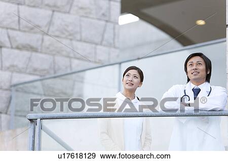 Stock Photo - Male Doctor and Femlae Nurse. Fotosearch
