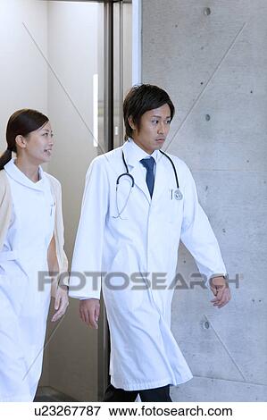 Male Doctor and Femlae Nurse Walking View Large Photo Image Stock Photo - Male Doctor and Femlae Nurse Walking. Fotosearch