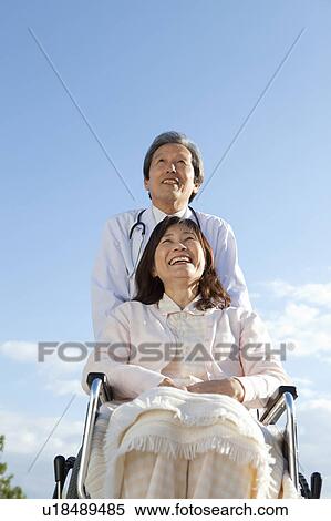 Male Doctor with Mature Woman in Wheelchair View Large Photo Image Stock Photography - Male Doctor with Mature Woman in Wheelchair. Fotosearch