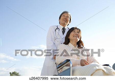 Male Doctor with Mature Woman in Wheelchair View Large Photo Image Stock Photography - Male Doctor with Mature Woman in Wheelchair. Fotosearch