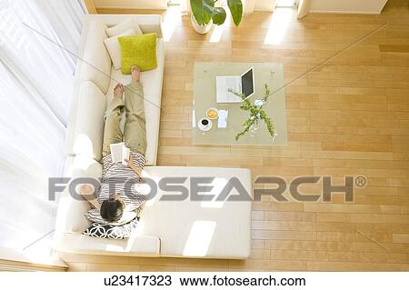 Man relaxing on sofa View Large Photo Image Stock Image - Man relaxing on sofa. Fotosearch
