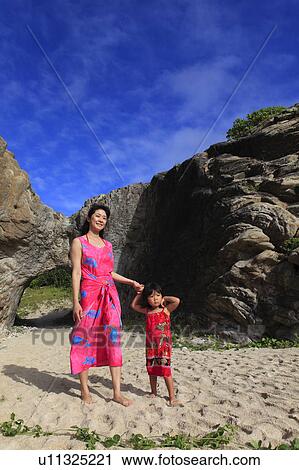 Stock Image - Mother and Daughter Walking on Beach. Fotosearch