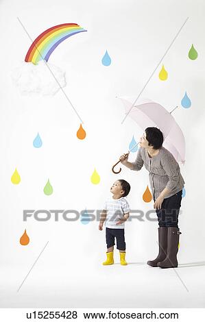 Mother and Son in Rain Looking At Rainbow View Large Photo Image Stock Photo - Mother and Son in Rain Looking At Rainbow. Fotosearch