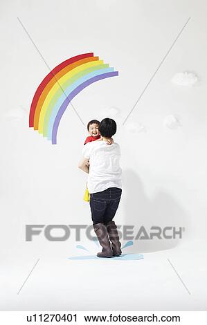 Stock Image - Mother and Son Under Rainbow. Fotosearch