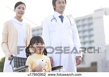 Stock Image - Nurse, Doctor and Girl in Wheelchair. Fotosearch