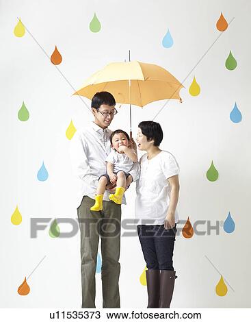 Stock Image - Parents and Son in Rain. Fotosearch